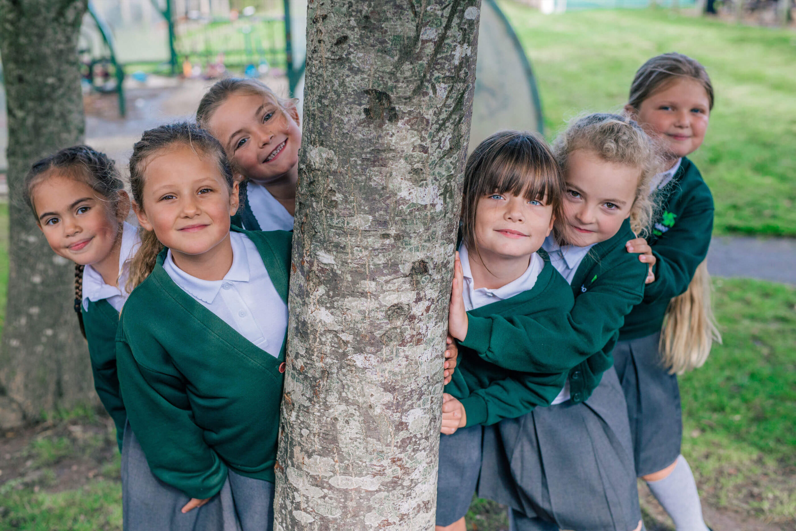 School children next to a tree